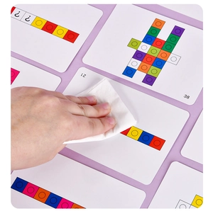 Close-up of erasable logic training cards showing smooth wipeable surface and colorful cubes
