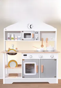 Detailed view of white and grey wooden play kitchen with clock, sink, and cooking accessories