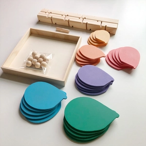 Detailed view of colorful wooden tree petals and rainbow ball run components on white background