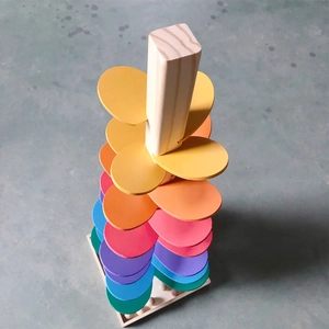 Detail view of colorful wooden marble run singing tree with rainbow petals for kids