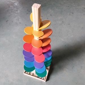 Macro shot of colorful wooden music tree leaves and cascading rainbow marble track layers