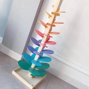 Detailed view of spiral rainbow wooden musical tree with colorful gradient petals