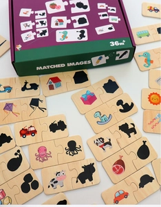 Close-up of wooden shadow matching puzzle pieces with animal and vehicle illustrations