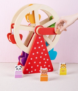 Detail of wooden animal ferris wheel toy showing a hand rotating the red handle smoothly