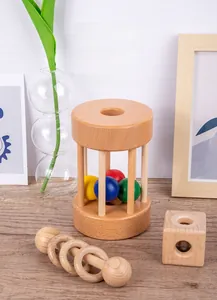 Detail of natural beech wood rattles and colorful balls for infant sensory development