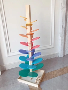 Detailed view of wooden rainbow music tree with colorful petals and square base