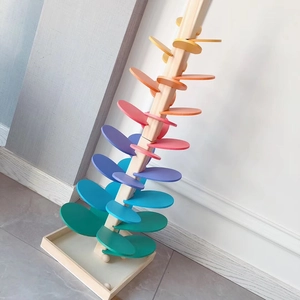 Detail of wooden rainbow singing tree toy with colorful musical leaves and sturdy base