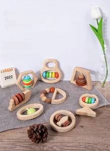 Macro view of wooden baby rattles set on a textured fabric for sensory play