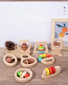Detail view of smooth wooden baby rattle toys with colorful beads for grasping training