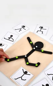 Macro view of wooden toy man on base with cards for limb movement and logic training