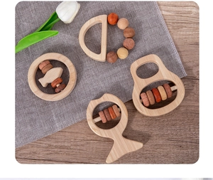 Macro shot of 4-piece wooden baby rattle set with smooth beads for sensory grip training
