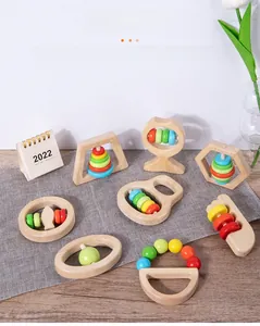 Close-up of baby wooden rattle toys with colorful beads for teething and sensory training