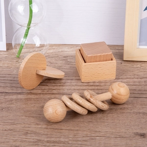 Montessori wooden rattle and block toy set for infants focusing on grasping and early learning