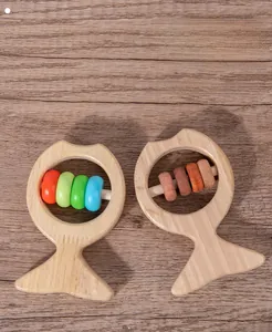 Detailed view of fish-shaped wooden baby rattle toys in natural and colorful finishes