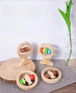 Detail of natural wood baby rattle set with colorful beads for grasping and teething