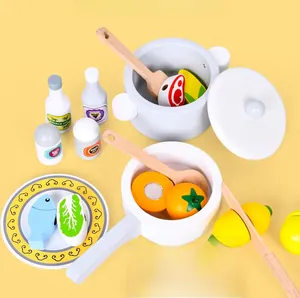Detailed overhead view of colorful wooden play kitchen set with toy cookware and vegetables