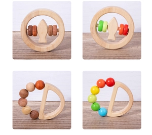 Detail showing natural wooden baby rattle set with smooth fish and beads designs