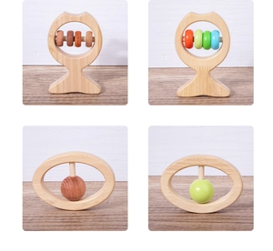 Detail view of four smooth wooden baby rattles with colorful rings and animal shapes