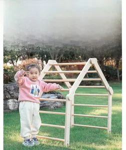 Detail of wooden climbing frame showing sturdy rungs and natural wood texture on lawn