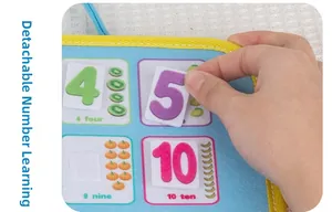 Detail of hand placing velcro number 5 on felt busy board for kids math learning