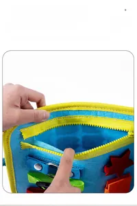 Detail of felt busy board featuring yellow zipper pocket and sensory training components
