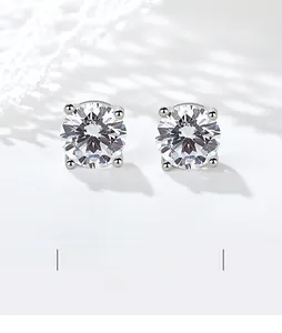 Detailed close-up of 925 sterling silver four-prong stud earrings with round-cut stones