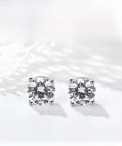Detailed macro view of 925 sterling silver four-prong stud earrings with round-cut crystals