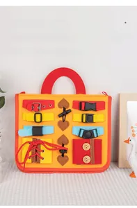 Detail view of the felt busy board showing colorful buckles, laces, and buttons for kids