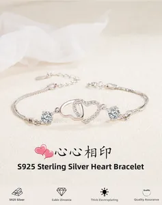 Close-up of S925 sterling silver interlocking heart bracelet with cubic zirconia and snake chain