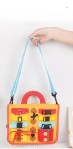 Detail of Montessori busy board with buckles and straps for kids sensory learning