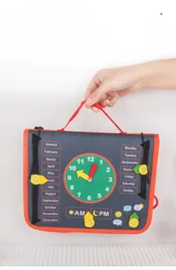 Detail of Montessori busy board showing clock, calendar, and weather learning modules