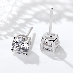 Elegant 925 sterling silver four-claw stud earrings with sparkling round cubic zirconia