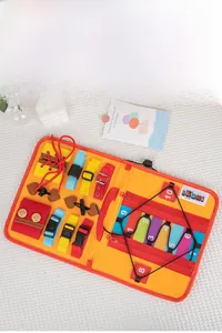 Close-up of Montessori busy board featuring buckles, zippers, and number tiles for toddlers