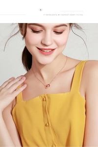 Rose gold Mobius double ring necklace with pavé crystals worn on a model in close-up