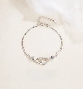 Detailed view of S925 sterling silver double heart bracelet with cubic zirconia inlay