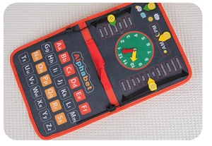 Detail of Montessori busy board with felt alphabet, clock, months and weekdays