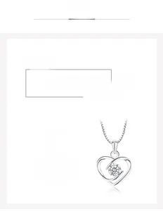 Detailed close-up of hollow heart silver pendant with a central round cut crystal gem