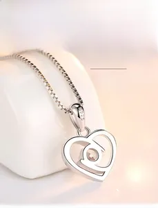 Detailed view of S925 sterling silver heart pendant with sparkling round cubic zirconia