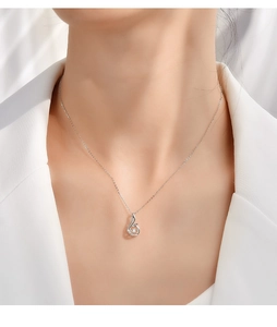 Close-up of S925 silver phoenix necklace with a dancing zircon stone on a model