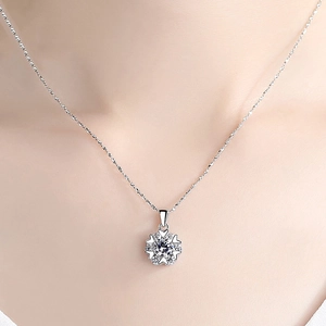 Macro detail of S925 silver snowflake necklace with sparkling heart-shaped zircon stones
