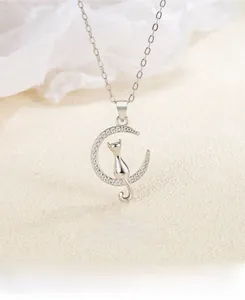 Macro shot of S925 sterling silver moon and cat pendant necklace with white zircon