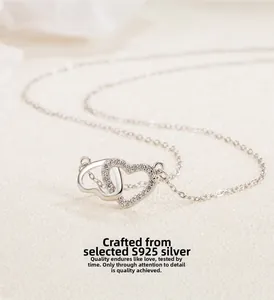 Macro shot of S925 sterling silver interlocking double hearts pendant with cubic zirconia