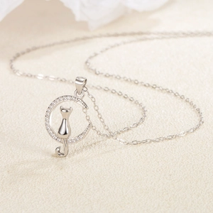 S925 Sterling Silver moon cat necklace with sparkling cubic zirconia on a warm background
