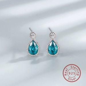 Detailed macro view of S925 sterling silver drop earrings with sea blue crystal stone