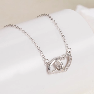 Polished S925 sterling silver interlocking heart necklace with sparkling zircon crystals