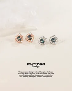 Detail view of galaxy planet stud earrings featuring blue sandstone and cubic zirconia