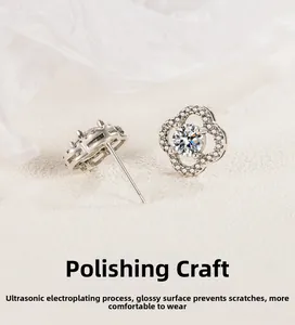 Detail of s925 silver clover earrings with sparkling clear stones and polished finish