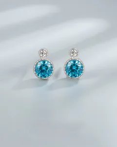 Detail of Heart of the Ocean earrings featuring blue round stones and silver backing