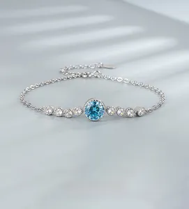 Macro shot of silver Heart of the Ocean bracelet with a large blue gem and white zircons