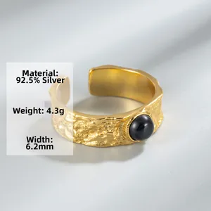Detail of s925 silver irregular hammer texture ring with black onyx stone setting